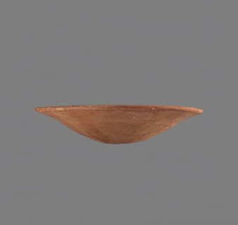 Bowl. Low bowl with irregular, strongly flaring walls and a rounded bottom. Rounded rim, slightly
