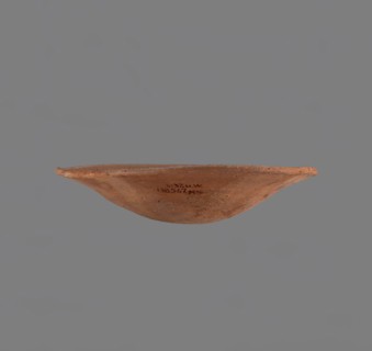 Bowl. Low bowl with irregular, strongly flaring walls and a rounded bottom. Rounded rim, slightly