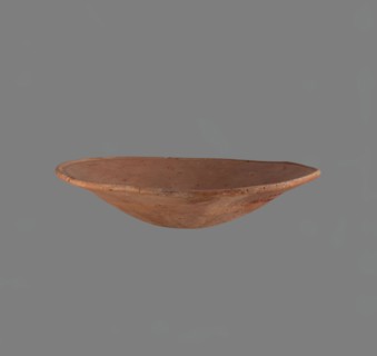 Bowl. Low bowl with irregular, strongly flaring walls and a rounded bottom. Rounded rim, slightly