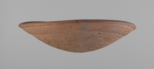 Shallow bowl of rounded, asymmetrical shape with rounded, flaring, irregular rim. Surface level;