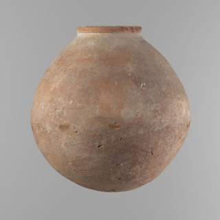 Vessel with an almost spherical belly, widest about 1/3 of the vessel's height. Sloping shoulders.