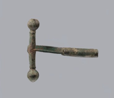 Onion-shaped fibula, Italy. Bronze fibula with hinged structure: an arched ring made from a