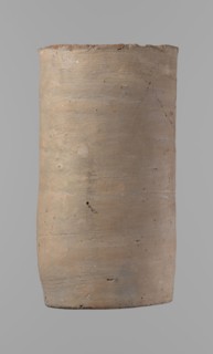 Canopic urn. Clay canopic urn with a cylindrical shape and a flat bottom and a flat, straight rim.
