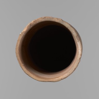 Canopic urn. Clay canopic urn with a cylindrical shape and a flat bottom and a flat, straight rim.