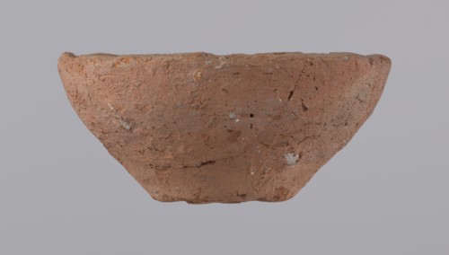 Bowl, probably votive, with a conical shape and a flat bottom. Straight rim, slightly curled