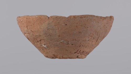 Bowl, probably votive, with a conical shape and a flat bottom. Straight rim, slightly curled