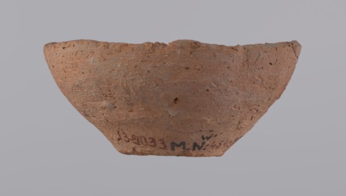 Bowl, probably votive, conical shape with a flat bottom. Straight rim, slightly curled toward the