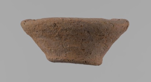Bowl, probably votive, conical shape with flat bottom. Irregular walls; straight, slightly flaring