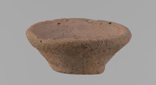 Bowl, probably votive, conical shape with a flat bottom. Irregular walls; straight, slightly