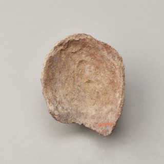 Female votive head. Female head with long, straight hair falling to the shoulders. Neck partially