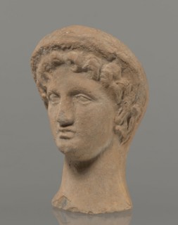 Female votive head, Female head in a wreath, slightly tilted to the right shoulder. Under the
