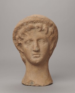 Female votive head, Female head in a wreath, slightly tilted to the right shoulder. Under the