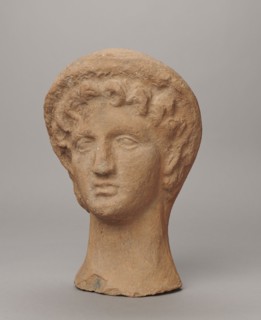Female votive head, Female head in a wreath, slightly tilted to the right shoulder. Under the