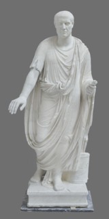 Roman statue, unknown Roman workshop. Figure of a striding man dressed in a tunic and toga. The