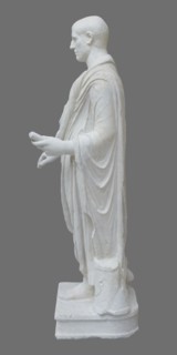 Roman statue, unknown Roman workshop. Figure of a striding man dressed in a tunic and toga. The