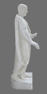 Roman statue, unknown Roman workshop. Figure of a striding man dressed in a tunic and toga. The