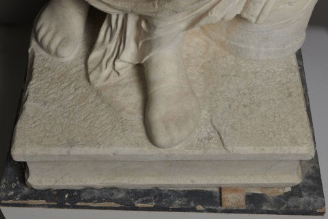 Roman statue, unknown Roman workshop. Figure of a striding man dressed in a tunic and toga. The