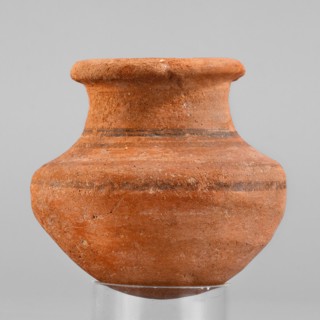 Vessel. A small wheel-made clay vessel with an almost hemispherical belly that transforms halfway