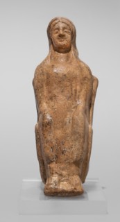 Figurine of a seated woman. Figurine of a woman sitting on a throne with her hands placed on her