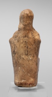 Figurine of a seated woman. Figurine of a woman sitting on a throne with her hands placed on her