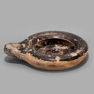 Oil lamp, Reddish, fine-grained clay. Low lamp with broad arms slightly curled inward. Large oil