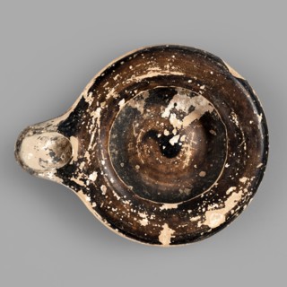Oil lamp, reddish, fine-grained clay. Low lamp with broad arms slightly curled inward. Large oil
