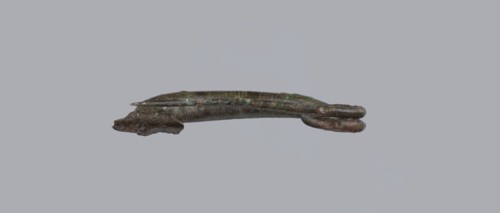 Arched fibula. One-piece fibula with an arched bow made of a round bar, decorated with groups of