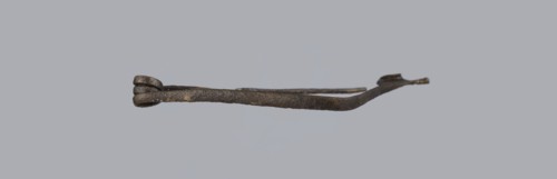 Fibula, bronze Etruscan fibula with a bent ring made of flatly beaten wire, passing in a three-turn