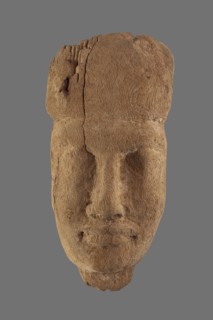 Sarcophagus mask with fragment of a wig above the forehead and a preserved piece of the neck. Very