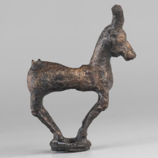 Emblem in the form of a figurine of a standing goat figurine of a standing gazelle with slightly