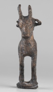 Emblem in the form of a figurine of a standing goat figurine of a standing gazelle with slightly