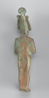 Figurine of Osiris depicted as a mummy-like standing figure wrapped in a shroud. The arms