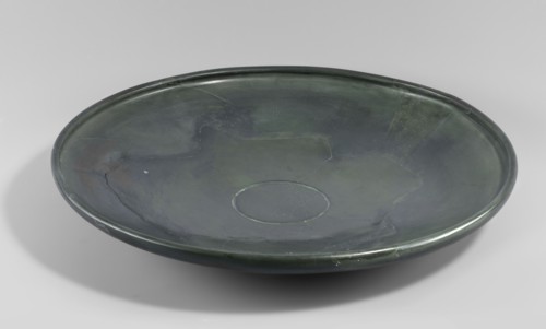 Plate, shallow stone plate with a convex bottom and a strongly flaring bowl; wide rim bent inward.