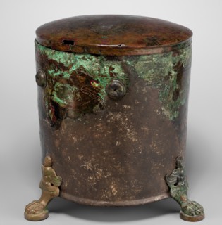 Cista container decorated with a depiction of the Dioscuri and Athena. Cylindrical vessel made of