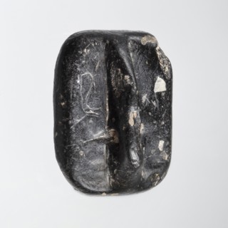 Rectangular stamp seal with a handle in the form of a protruding ridge along the axis of the seal