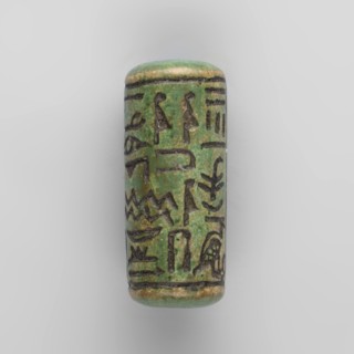 Cylinder seal with pseudo-hieroglyphs;, Cylindrical seal with a hole drilled along the cylinder.