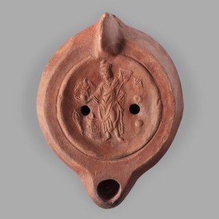 Lamp decorated with a representation of the goddess Roma with an eagle and a palm branch; at the