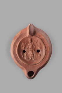 Lamp decorated with a representation of the goddess Roma with an eagle and a palm branch; at the
