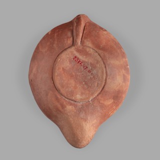 Lamp decorated with a representation of the goddess Roma with an eagle and a palm branch; at the