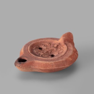 Lamp decorated with a representation of the goddess Roma with an eagle and a palm branch; at the