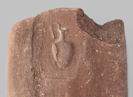 Fragment of a transport amphora vice with a stamp depicting an oinochoe and an incomplete Greek