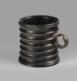 Dice cup. Small cup with a flat slightly concave bottom; walls slightly tapered; distinct rim and