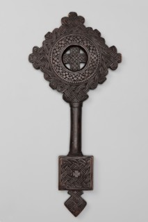 Hand-made equal-armed cross inscribed in a circular frame, surrounded by a braided ornament