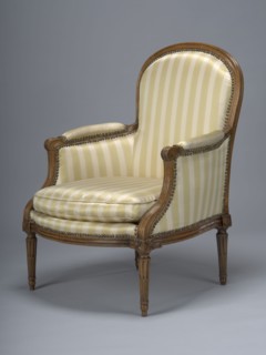 Armchair, covered with striped fabric with a loose cushion; wooden parts waxed. 4th quarter of the