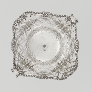 Openwork basket by Comyns & Sons London; goldsmiths' firm, fl. 1859–1953. Openwork basket on a