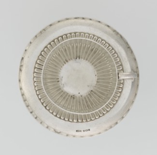Hemispherical cup and saucer, decorated with radiating curls to half the cup's height, with a