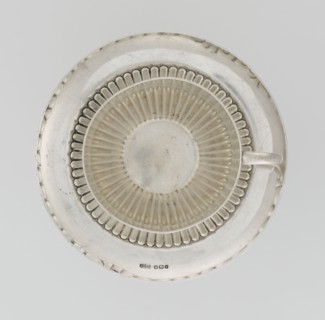 Hemispherical cup and saucer decorated with radiating curls to half its height; C-shaped side