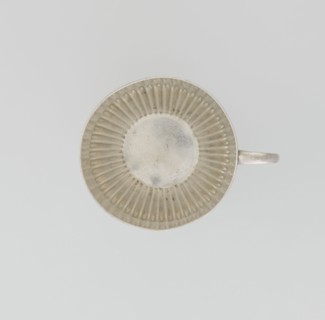 Hemispherical cup and saucer, decorated with radiating curls to half its height, with a C-shaped