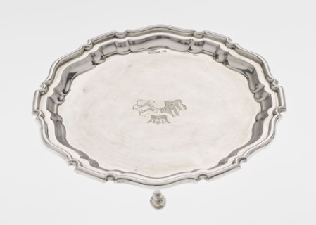 Tray on legs, ribbed circular tray supported on three hoof-shaped legs, with a slightly raised,