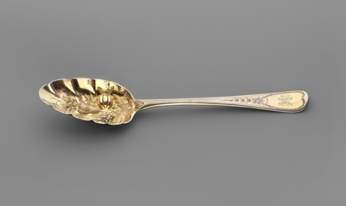 Jam spoon with an ovoid, serrated scoop decorated with a bunch of repoussé fruit; widening handle